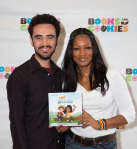 Garcelle Beauvais and her co-author, Sebastian Jones, holding their book "I Am Mixed"